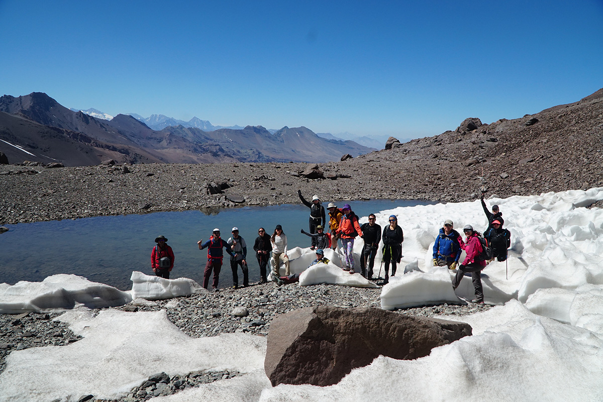 Group of mountaineers next to a snowdrift on the route to Cerro El Plomo, surrounded by snow in the Andes Mountains, Chile