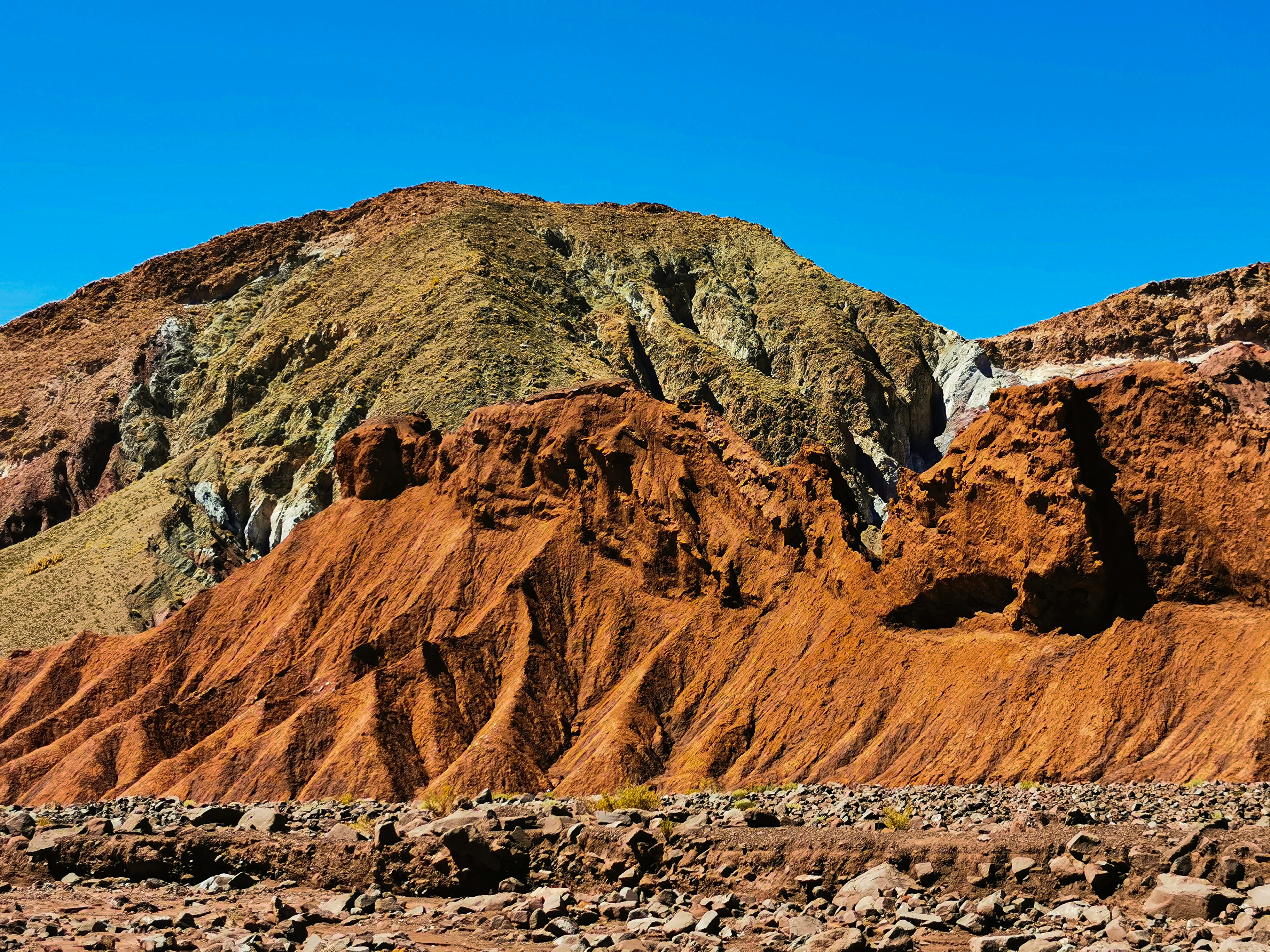 Reddish rock formations in the Rainbow Valley, Atacama Desert, Chile