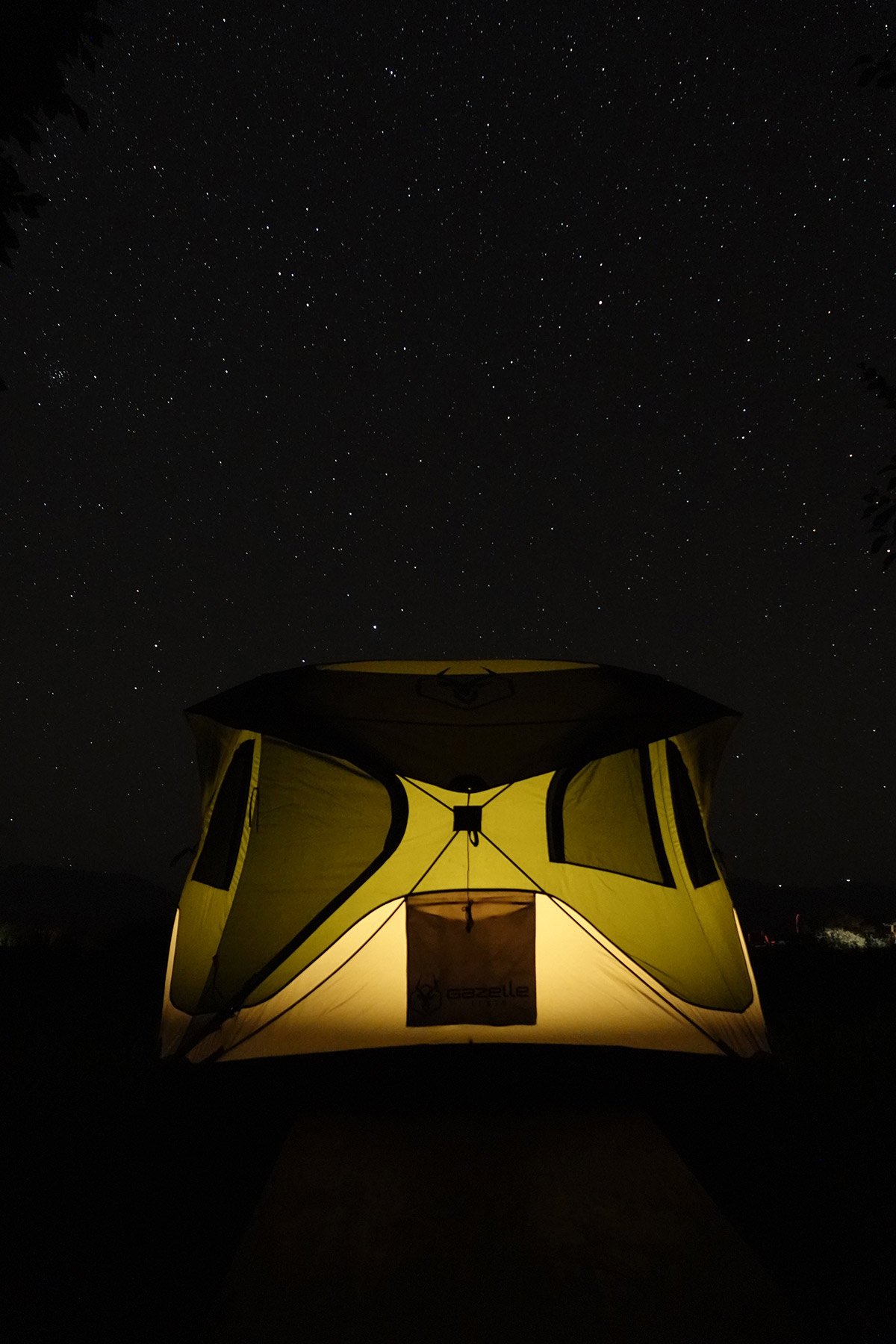 Illuminated tent under a starry sky during an astro camping experience in San Pedro de Atacama.