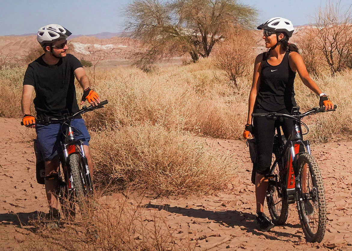 Couple on an electric bike safari through the Atacama Desert in San Pedro de Atacama.