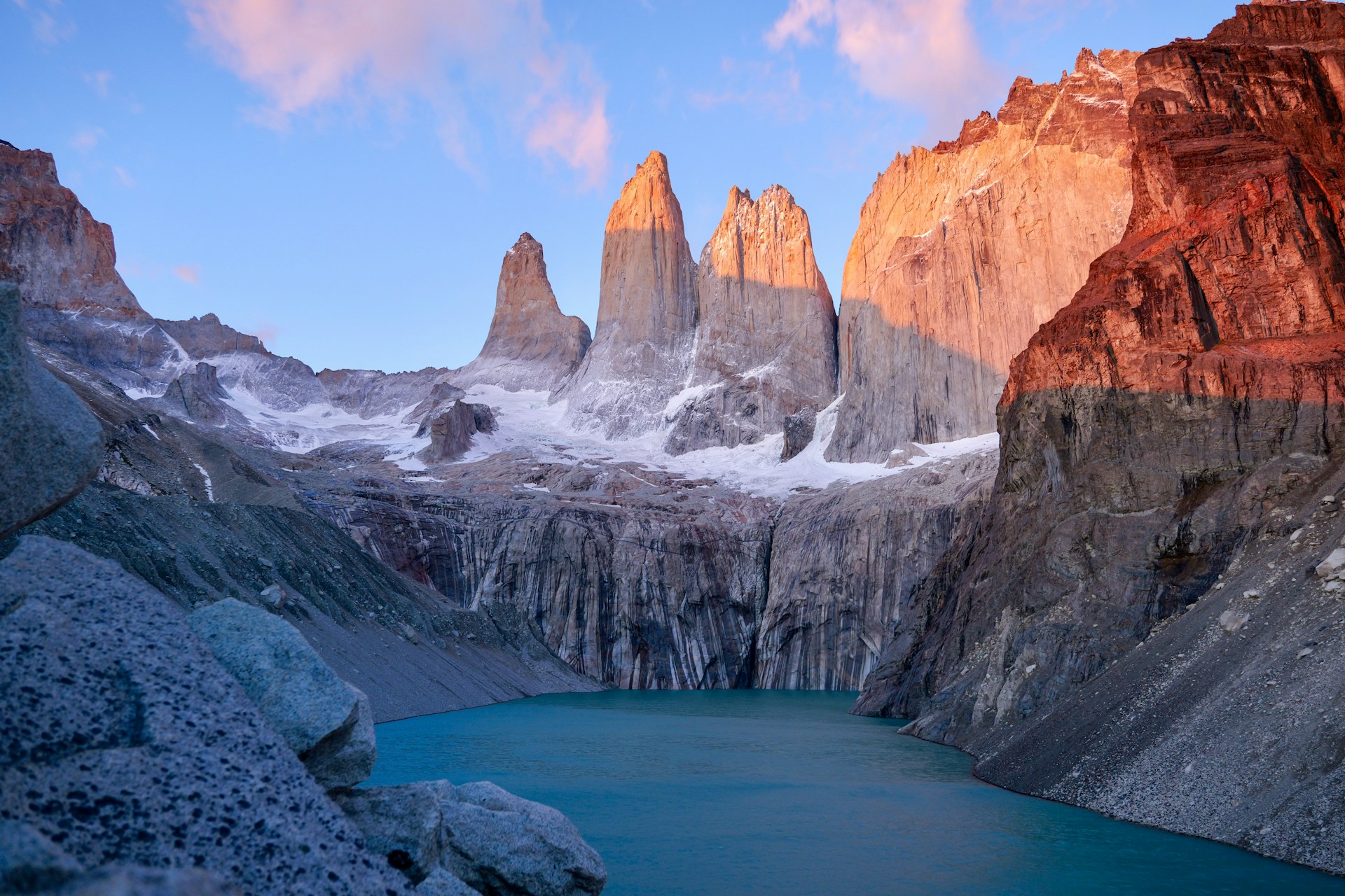Sunrise at the Base Torres del Paine with the turquoise lagoon and the Towers illuminated by the first light of the day in Torres del Paine National Park, Chile.
